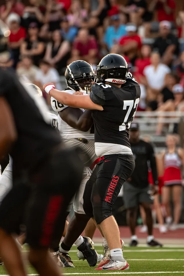 Ben Payne driving a block during a Colleyville Heritage freshman football game