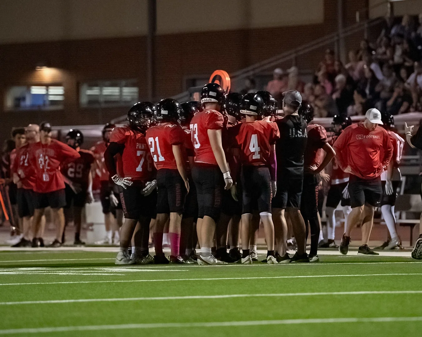 Colleyville Heritage freshman Black team huddled on the sideline during a game against Arlington Seguin